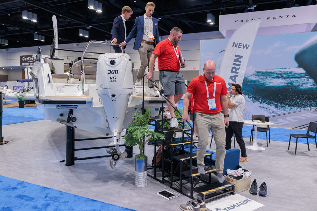 Dealers stepping down from a boat demo at Dealer Week 2024.