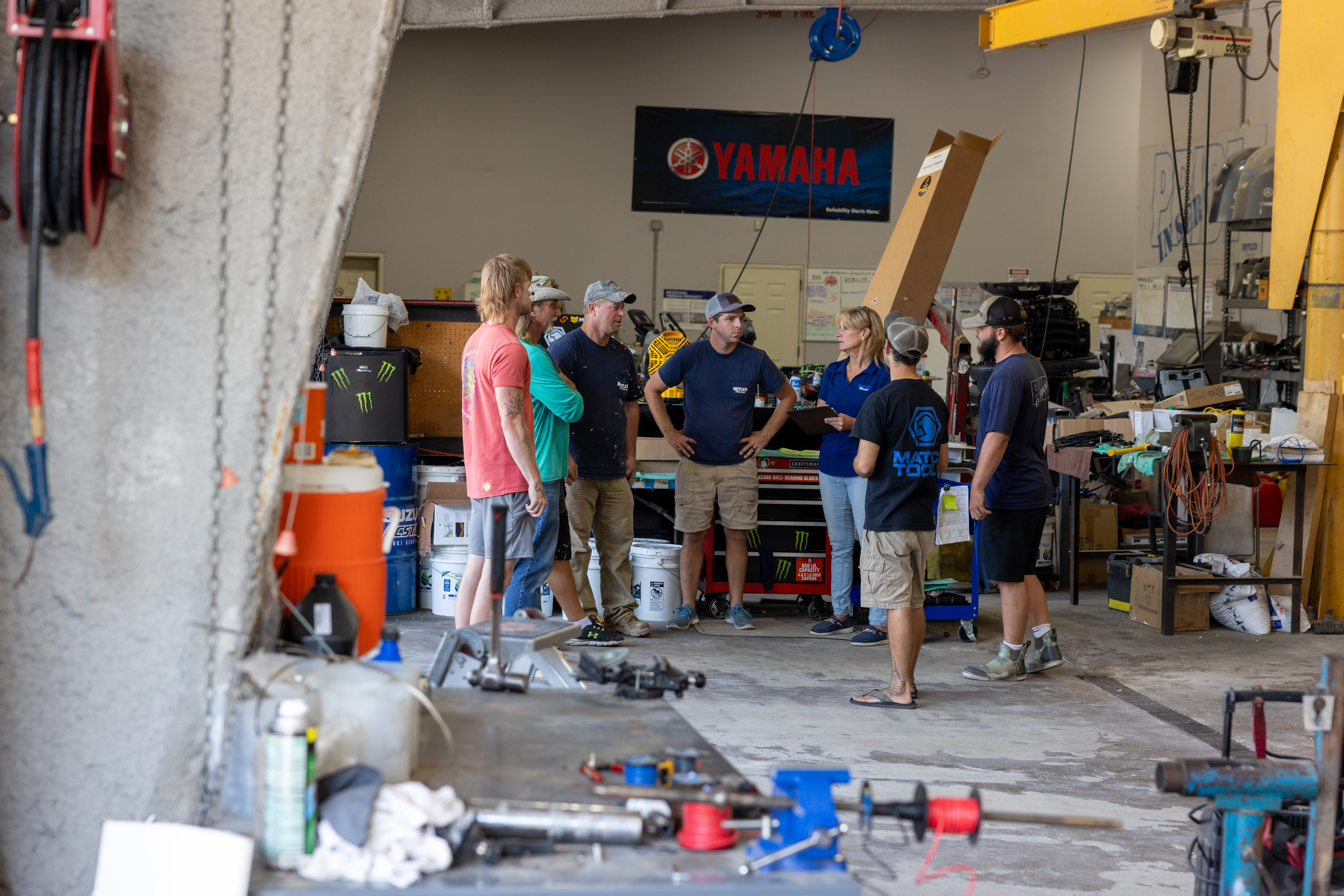 Marine dealership service department team having a meeting.