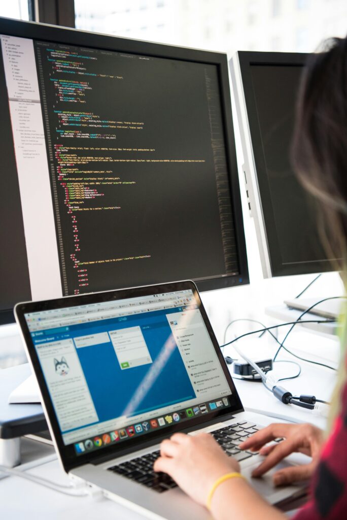 A remote employee working on multiple screens.