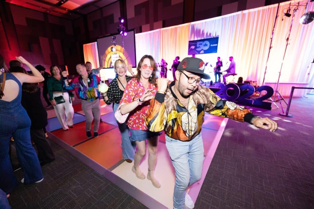 MRAA Industry Celebration photo of attendees dressed and dancing in 1970s outfits.
