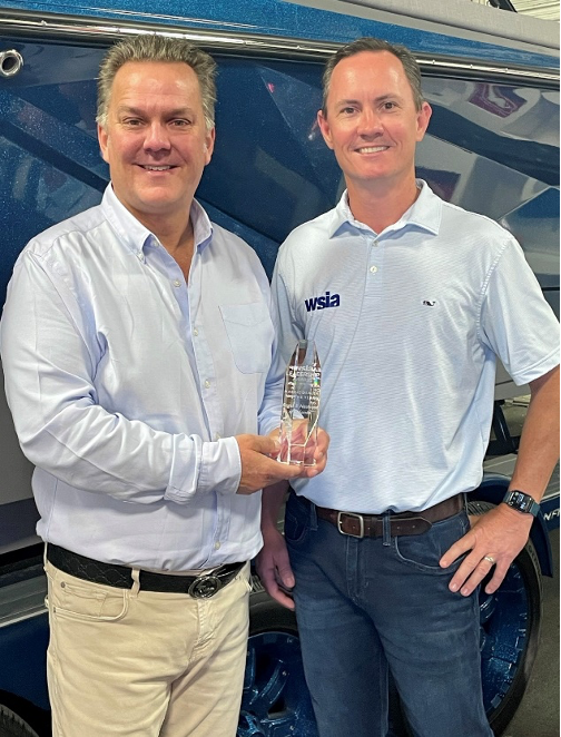 Regal Owner/GM Jeff Husby, left, accepts the international award for the Water Sports Industry Association’s “Marine Dealer of the Year” presented by WSIA Executive Director James Krawczyk.