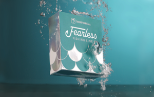 A box of Fearless Fishing Line, created (Takemefishign.org and Berkley) to encourage more women to get out on the water, landing in water.