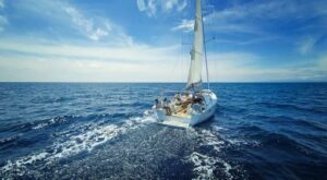 Image of white sailboat sailing on an open sea.