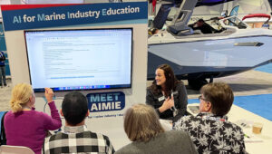 People in front of large monitor learning about a new marine industry artificial intelligence system, AIMIE, from MRAA.