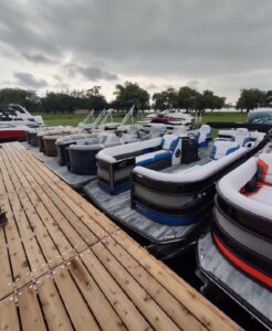 Pop-up boat show pontoons in field near portable dock