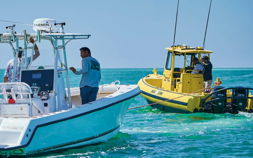 A boater who was stranded being rescued by a Sea Tow boat.