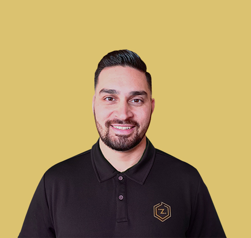 Headshot of writer Sid Humphreys, of ZiiDMS, wearing a black polo-type shirt with a yellow background