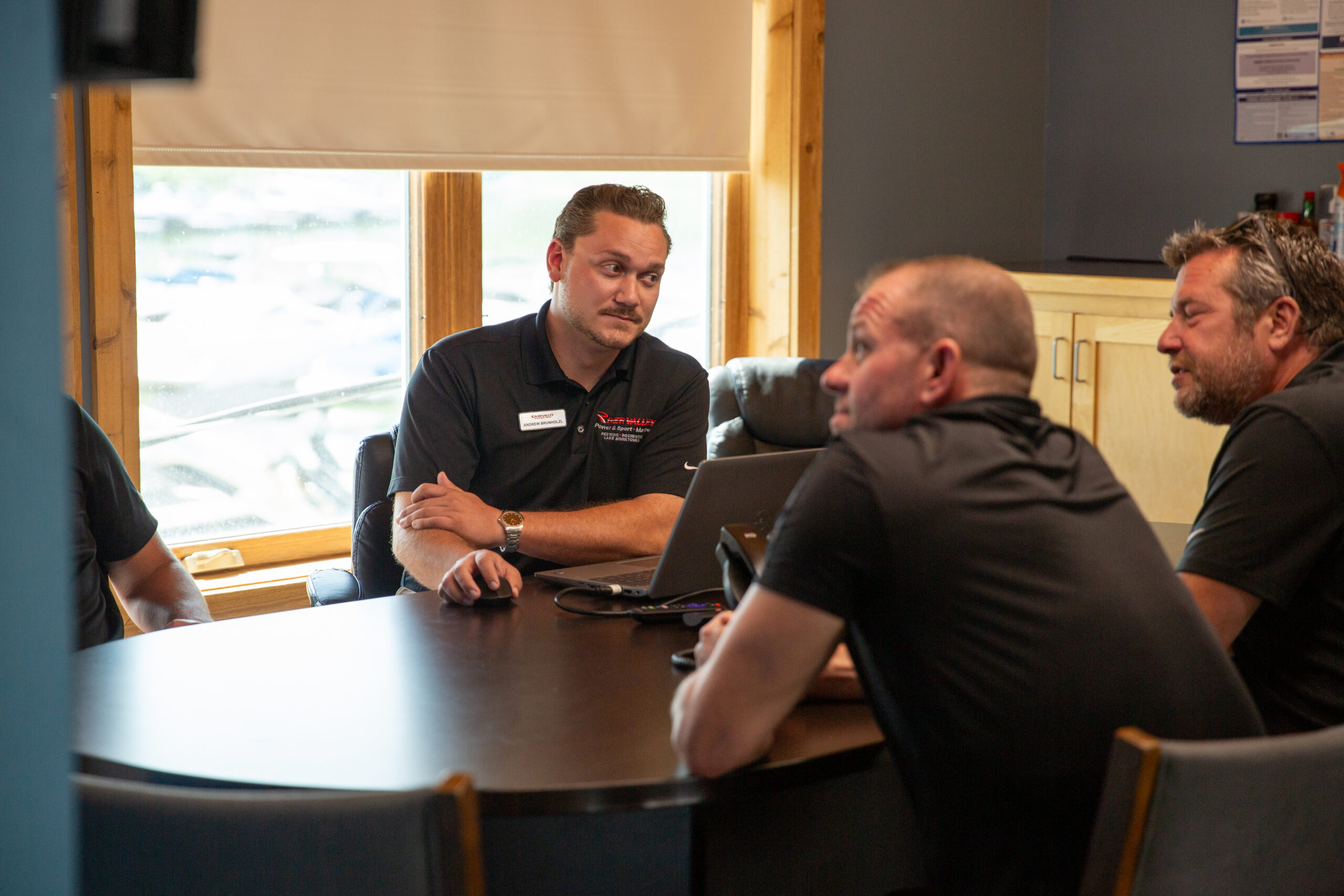 Photo of a sales manager walking his team through a project.