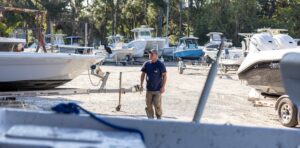 Service Tech working on fiberglass boats in Florida Boat Dealership