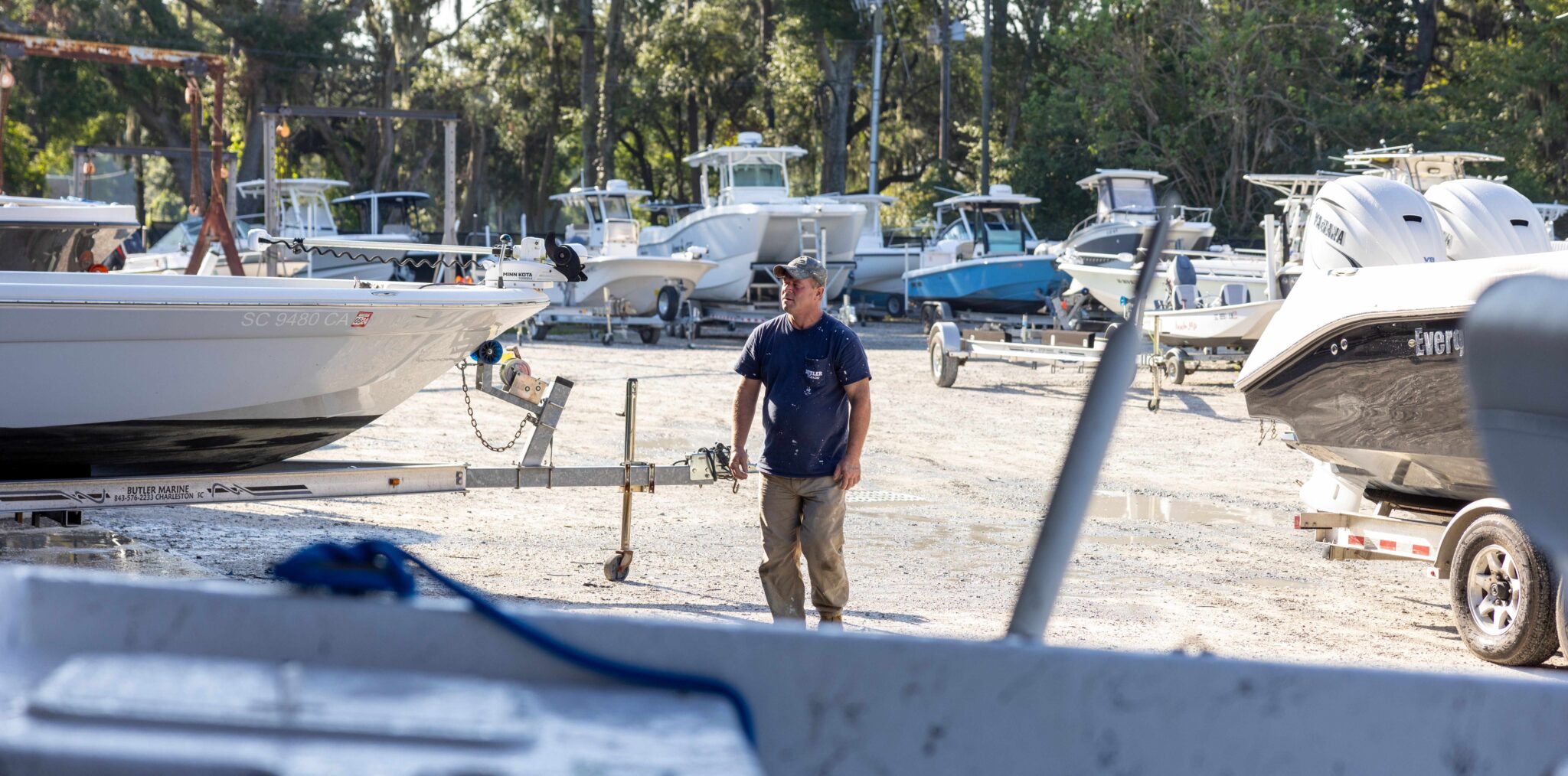 Service Tech working on fiberglass boats in Florida Boat Dealership