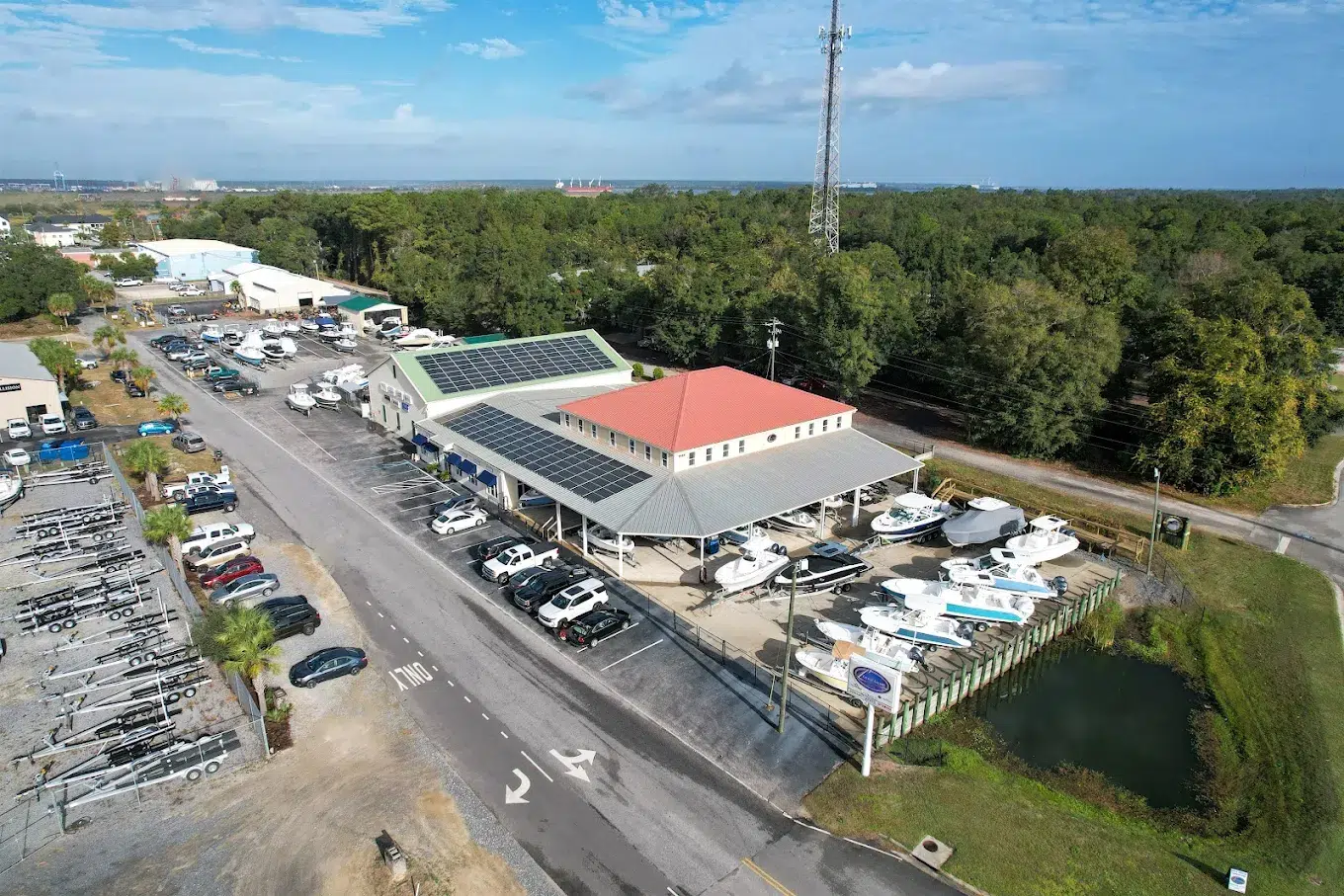 Aerial view of a boat dealership service facility with boats, service bays, and parking areas, representing service efficiency and operational improvement.