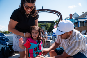 Young family preparing to go boating on pontoon