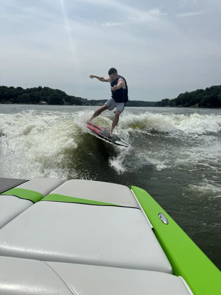 Wake surfing behind a boat demonstrating proper technique and boating access education